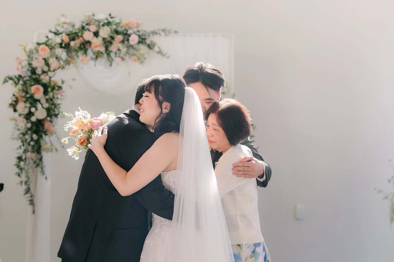Vivian hugging her parents at the front of the aisle