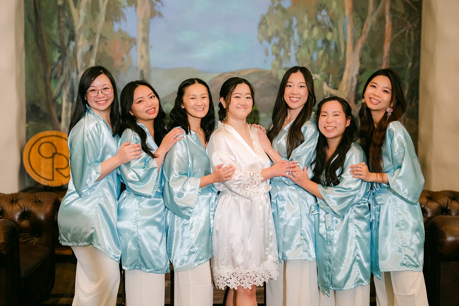 Jessica and her bridesmaids laughing in their robes