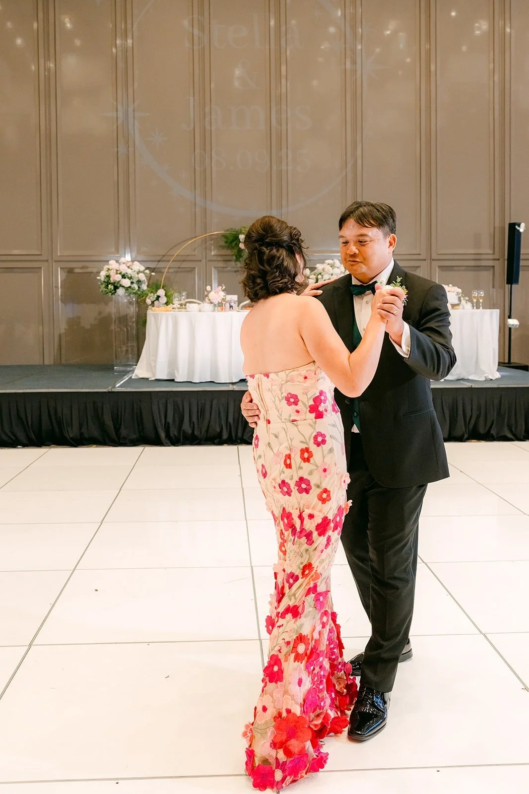 James dancing with a parent in a floral qipao
