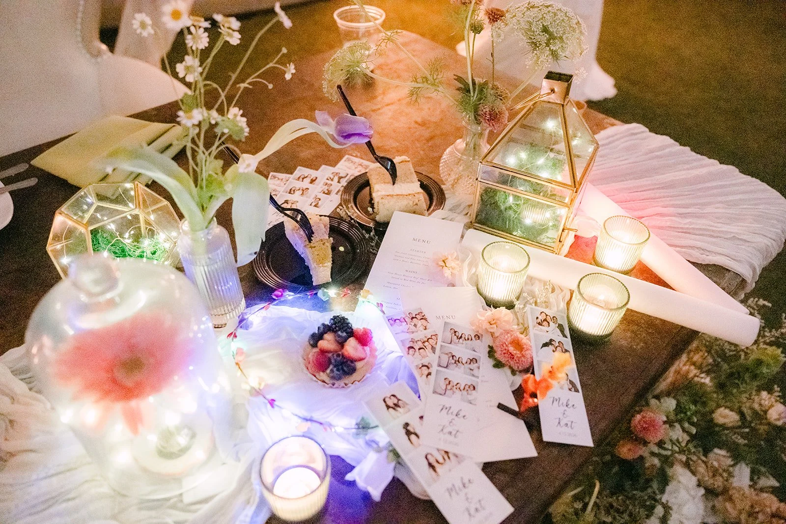 Light-up flower crowns and glowing favors on a reception table