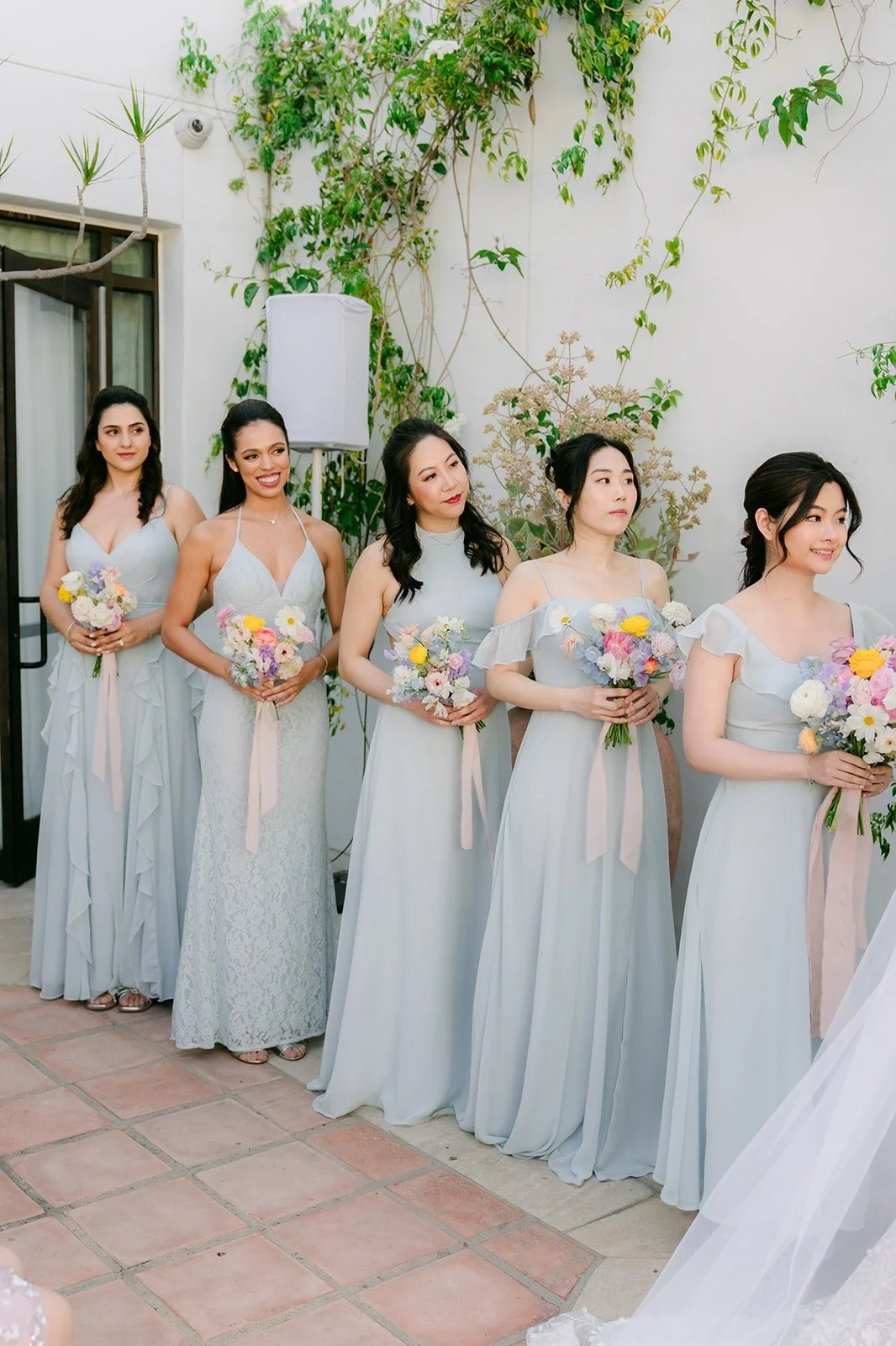 Bridesmaids in dusty blue lined up beside the altar