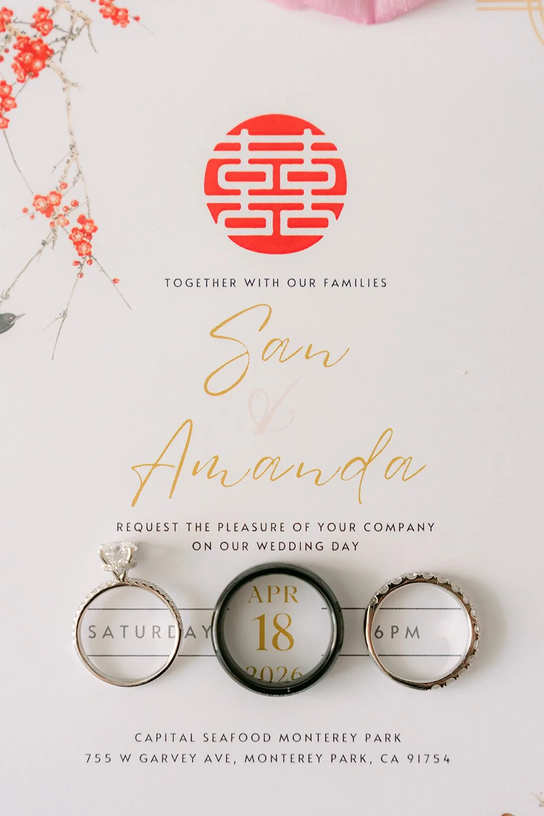 Amanda and San's double happiness invitation with their wedding rings.