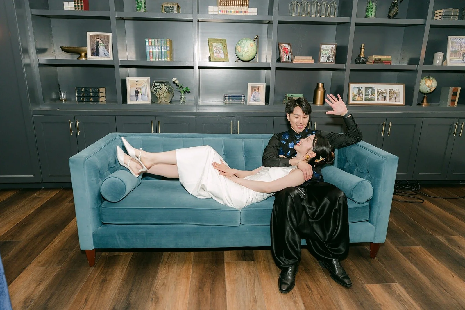 Tin and Fong relaxing on a blue velvet sofa, photographed by One and Only Production