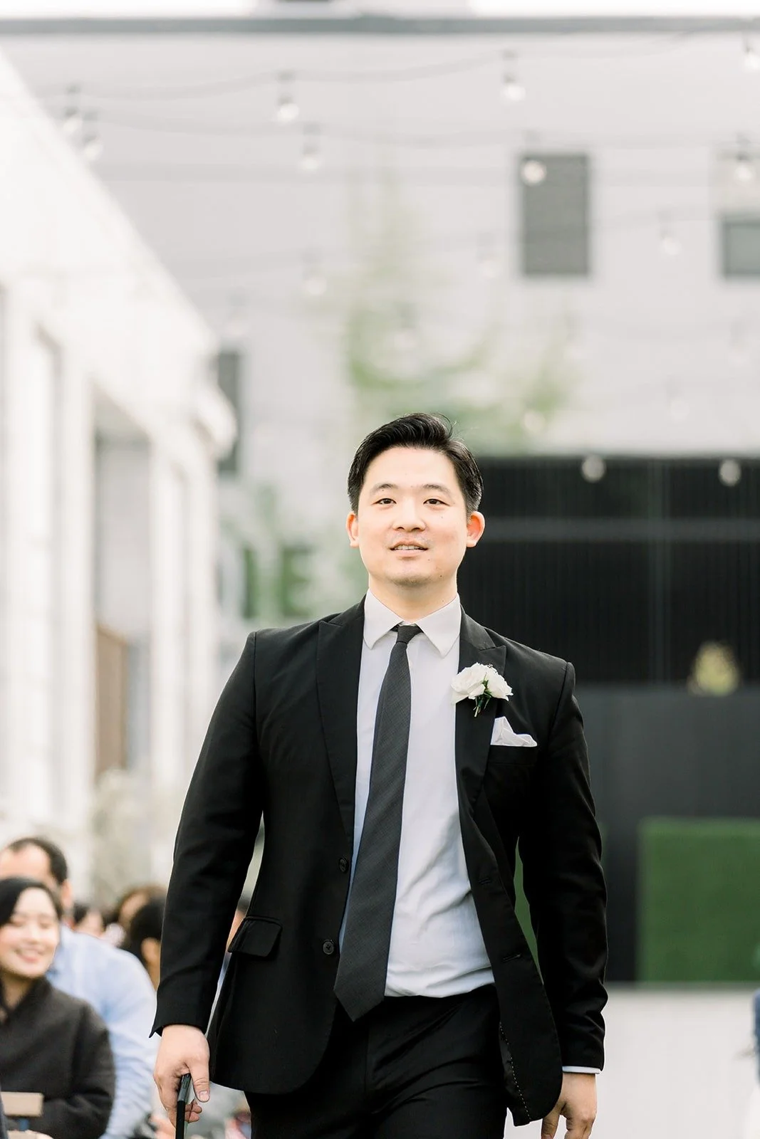 A groomsman walks down the aisle