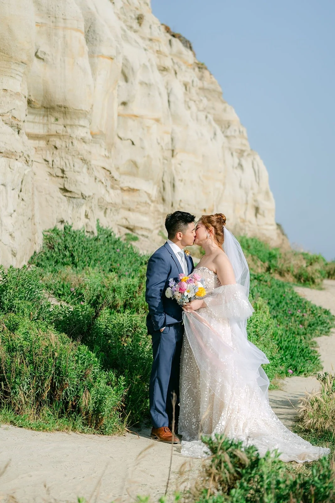 Joanna and Jerrick on the bluff path below the sandstone cliffs