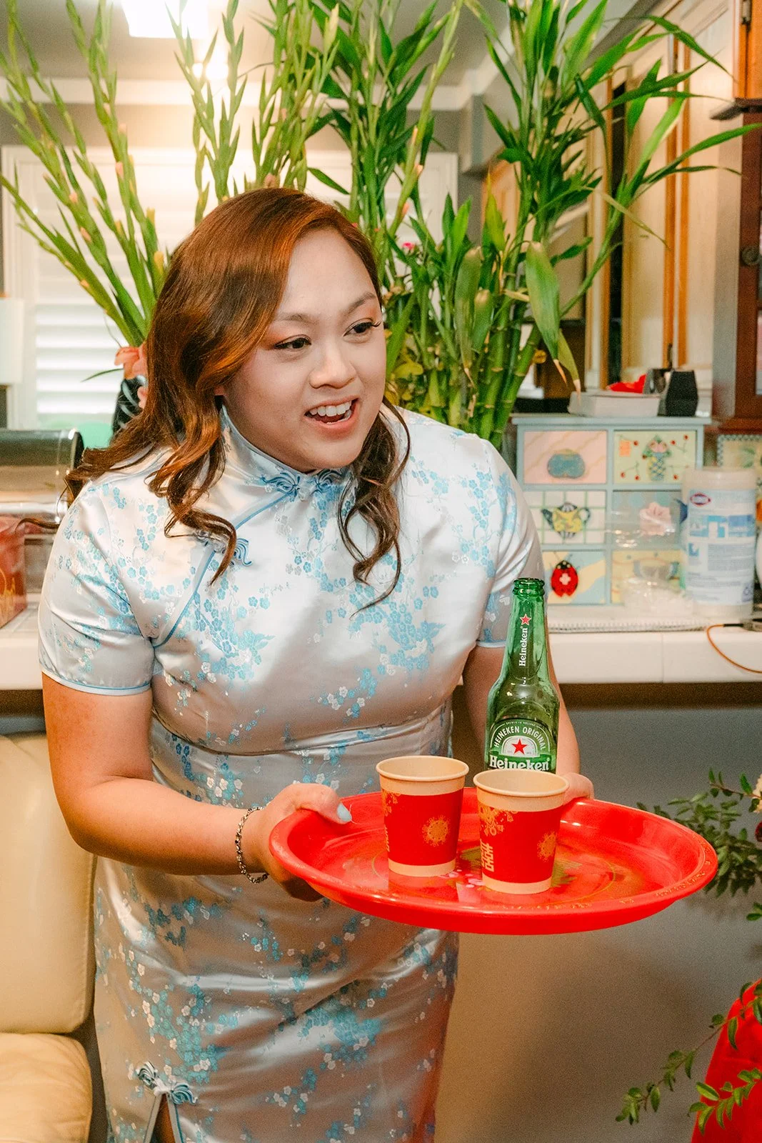 A relative carrying the tea tray across the room, photographed by One and Only Production.