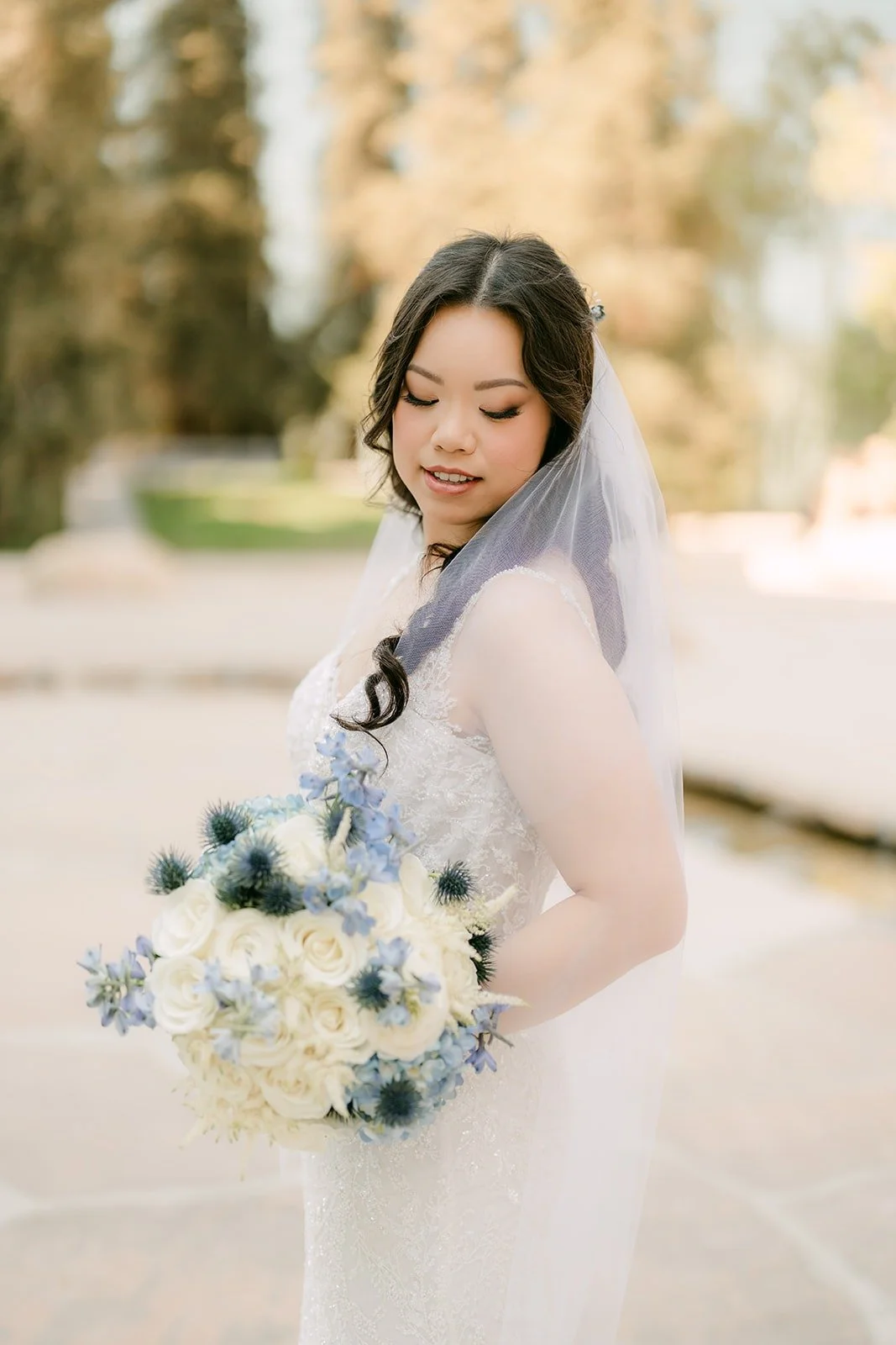 Emily smiling with her bouquet in soft afternoon light