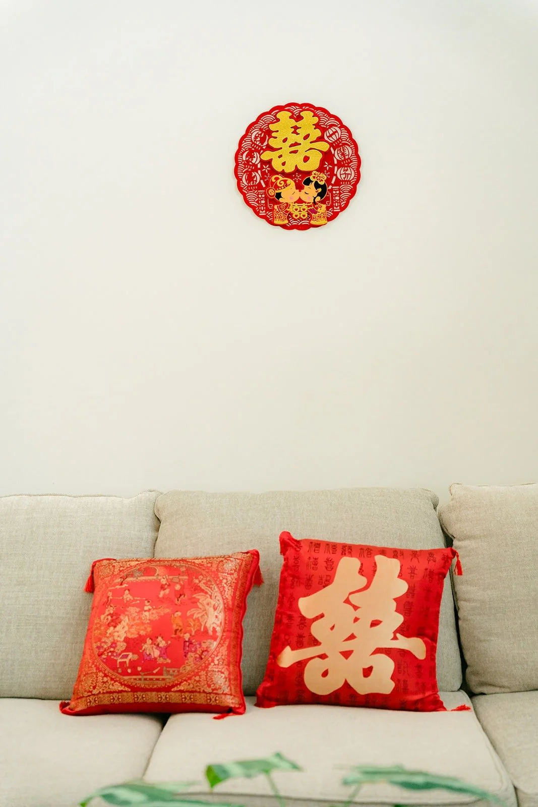 Red double happiness decor and pillows in the living room on the wedding morning