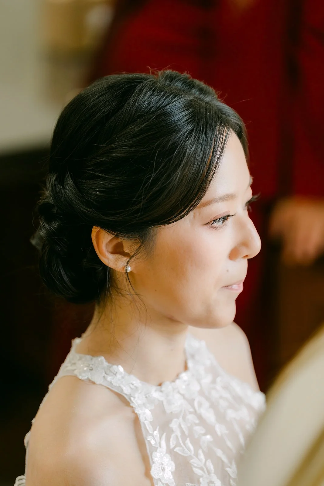 Elaine in profile with pearl earrings and a lace neckline.