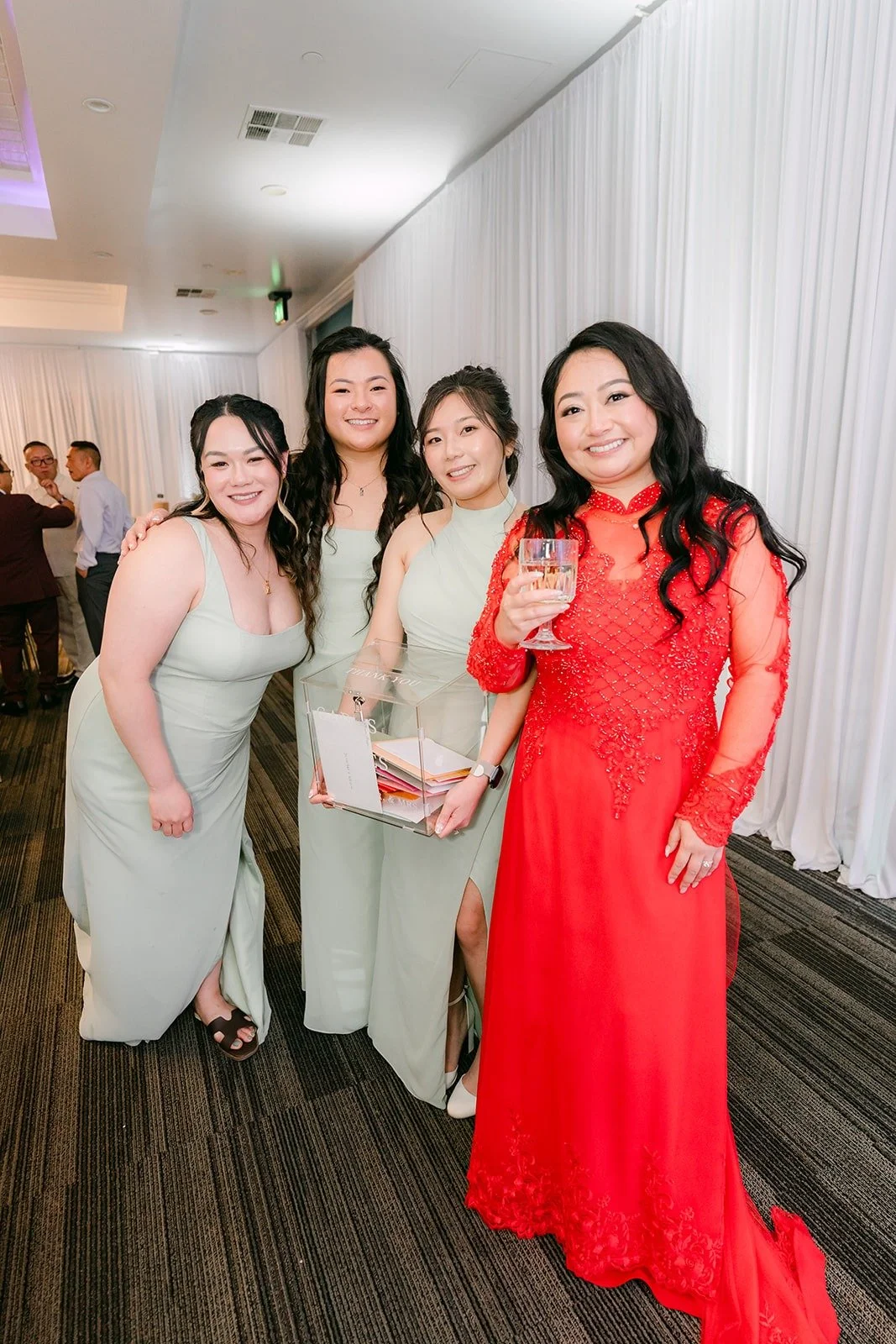 Jennifer in her red ao dai with her bridesmaids before table greetings