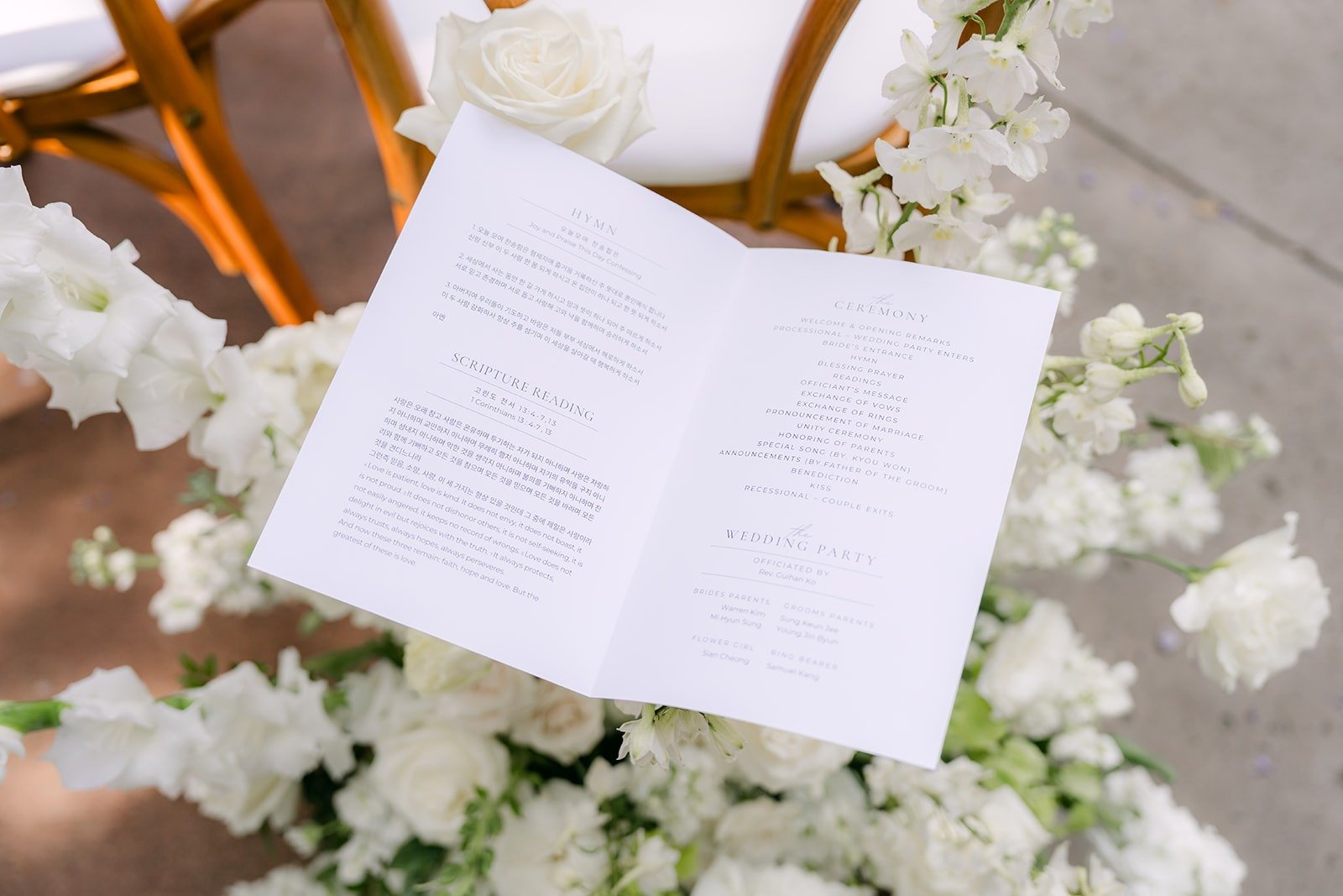 A ceremony program resting among white flowers