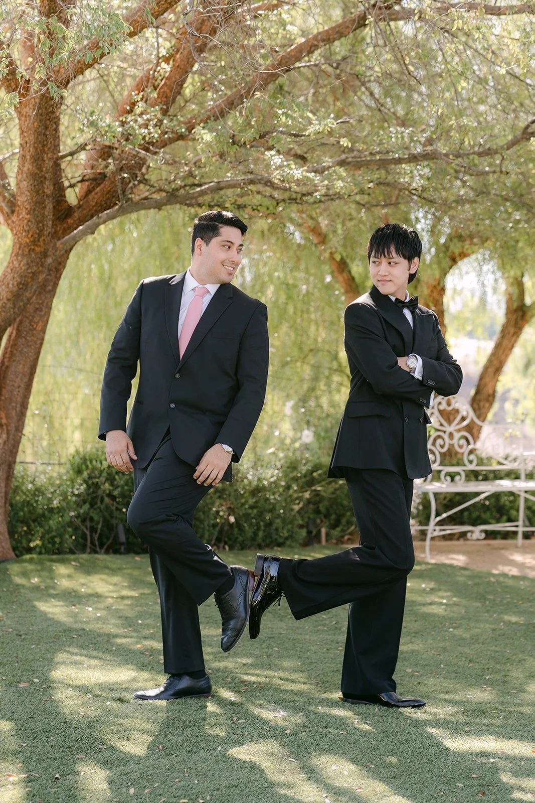 Job and a groomsman goofing around on the lawn