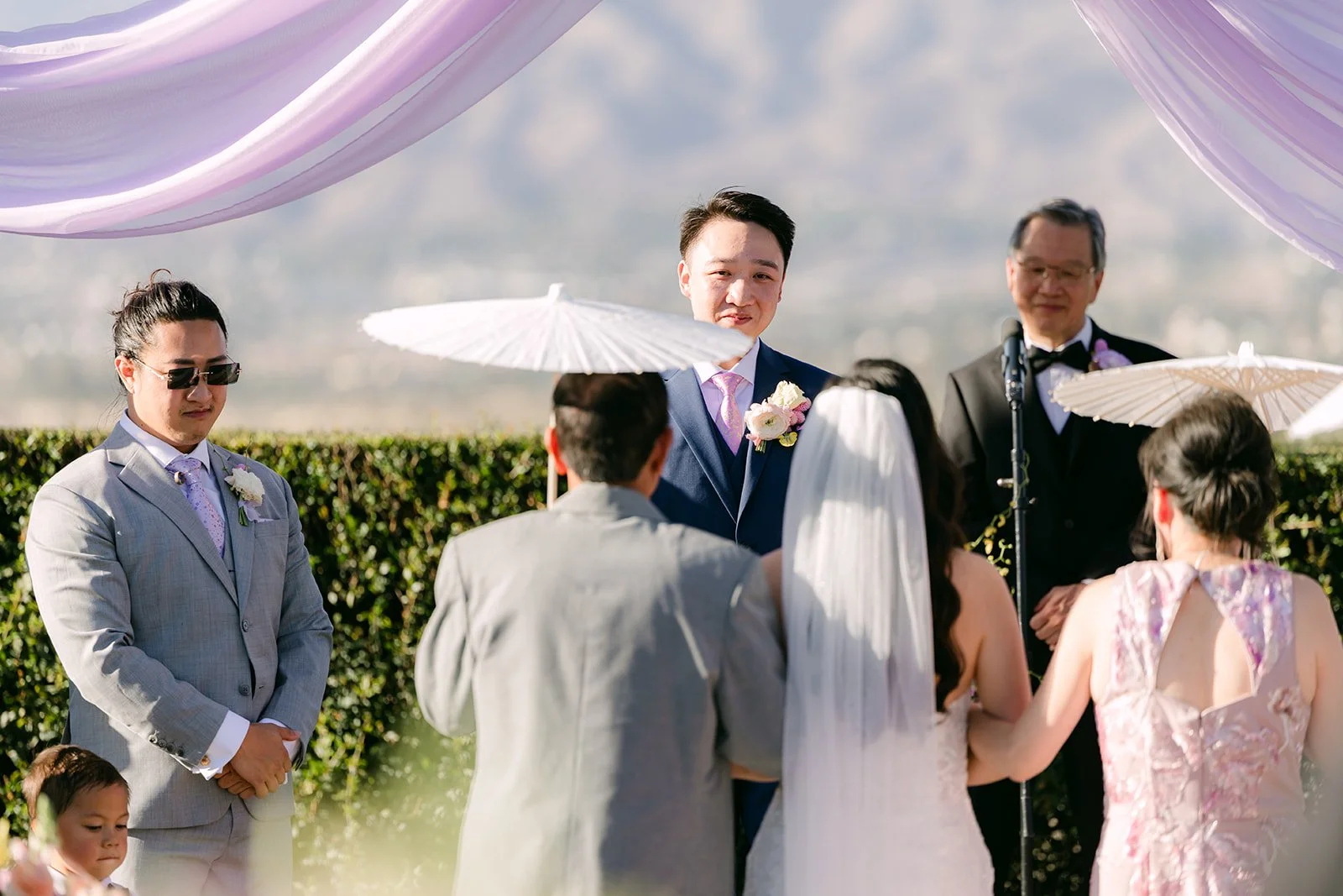 Elijah's dad officiating as Vannie and Elijah stand at the altar.