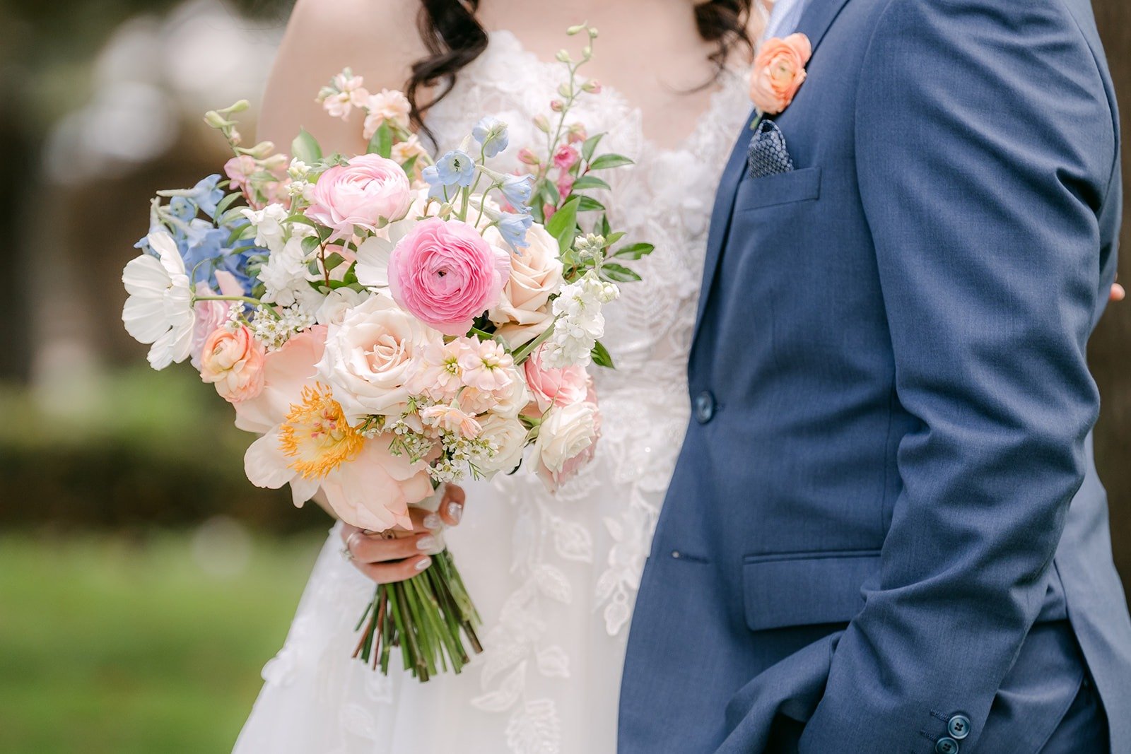 A close up of Natalie's bouquet held between Natalie and Mark