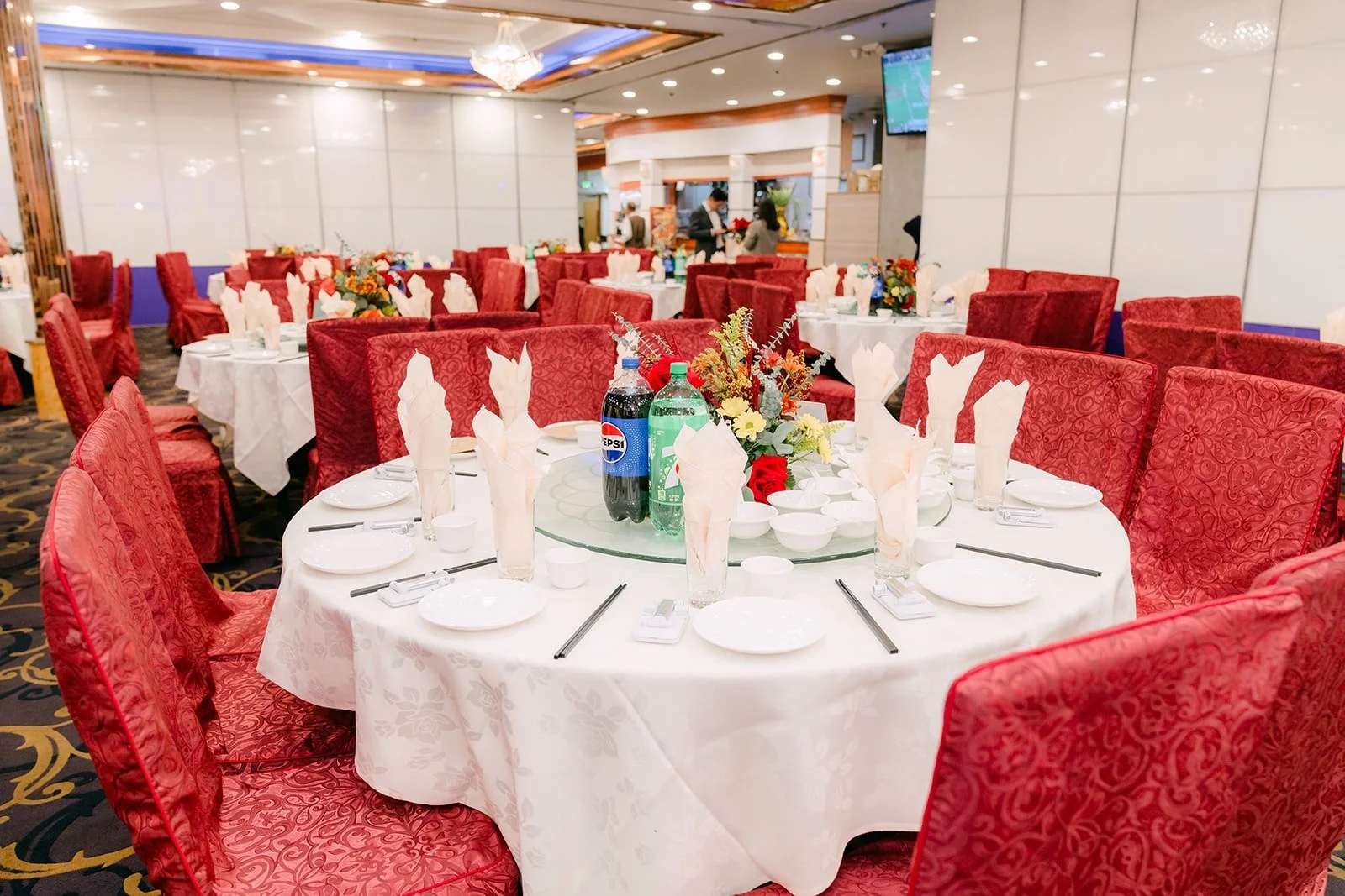 The banquet hall at 888 Seafood Restaurant set with round tables and red chairs
