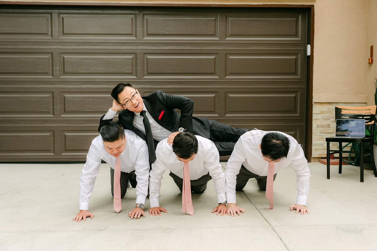 Groomsmen doing push ups as part of the door games