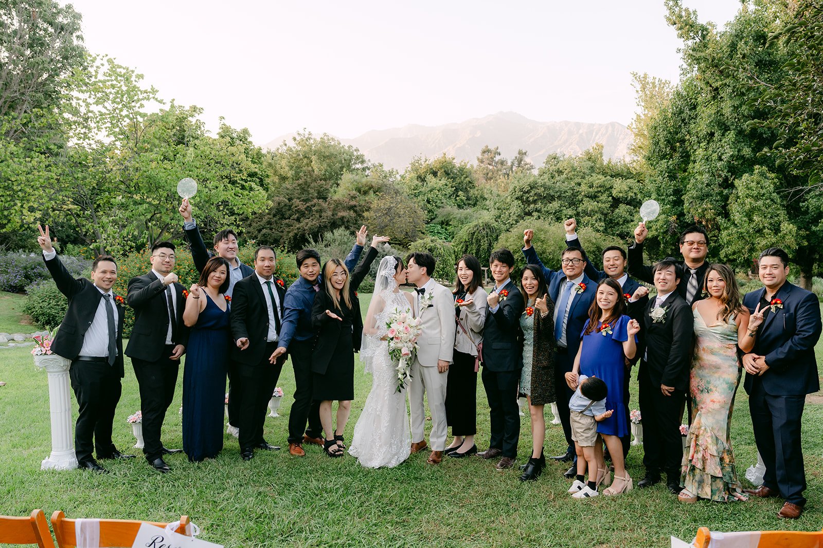 Elaine and Wen with family and friends on the lawn, photographed by One and Only Production.