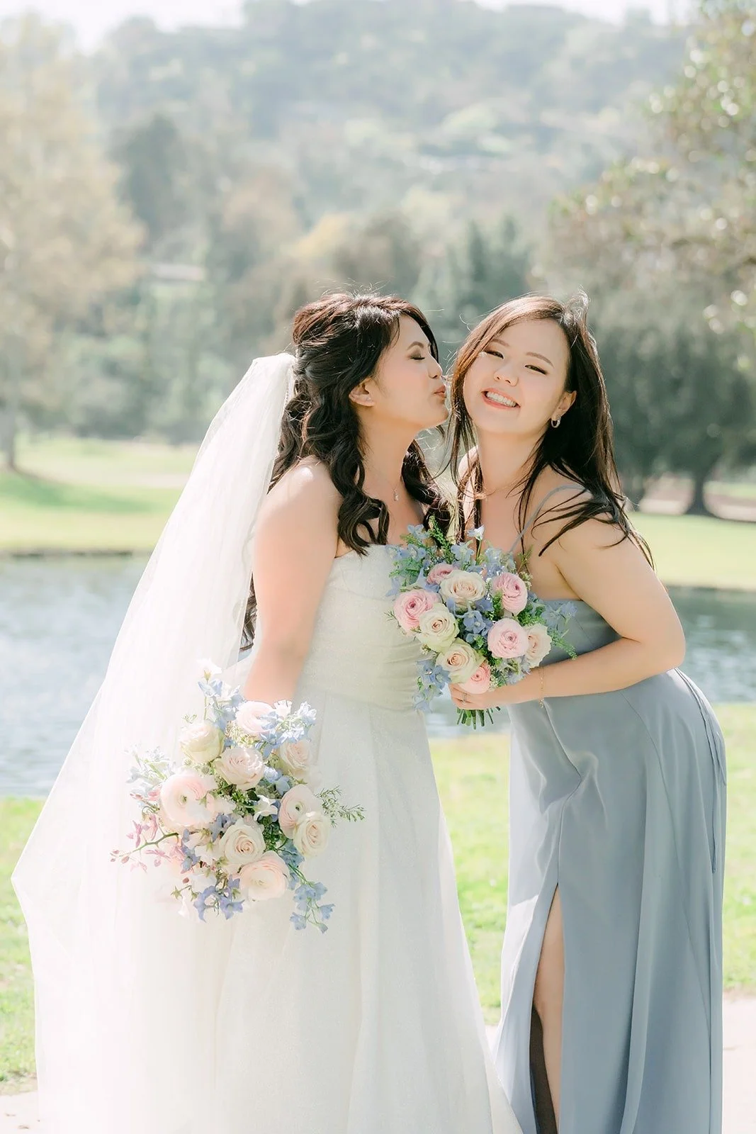 Florence sharing a laugh with a bridesmaid near the water