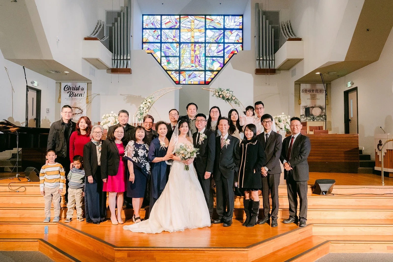 Eunice and Eric with family at the altar after the ceremony