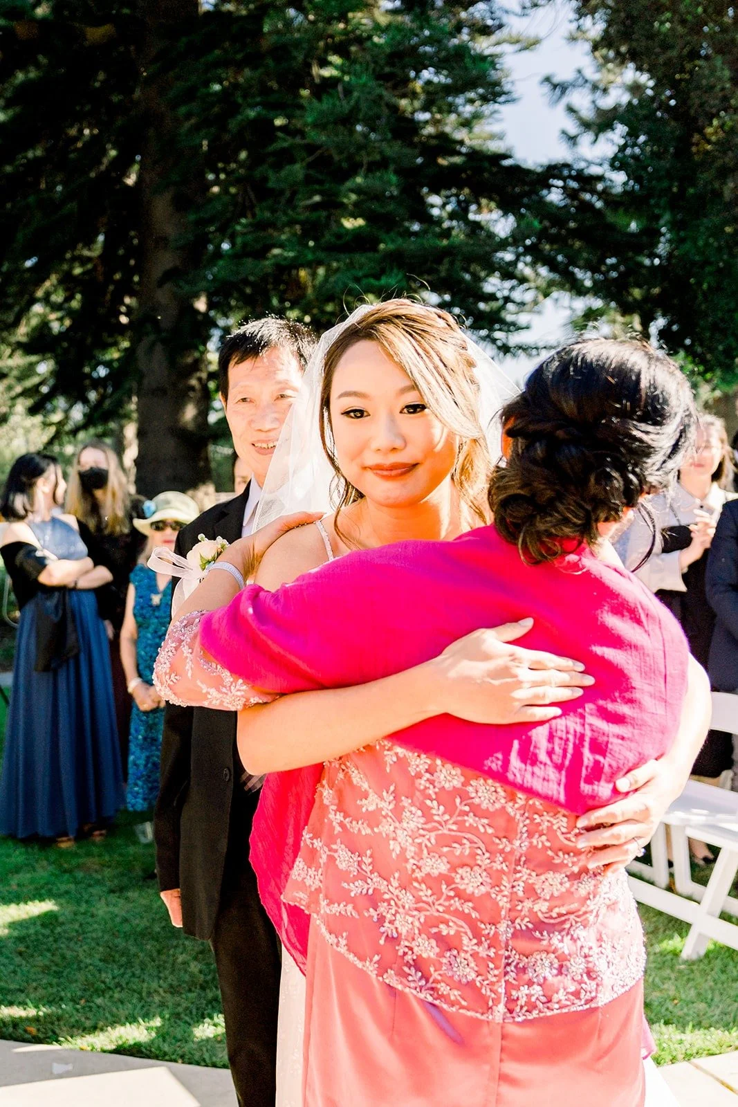 A family member hugging Ariel at the front of the aisle
