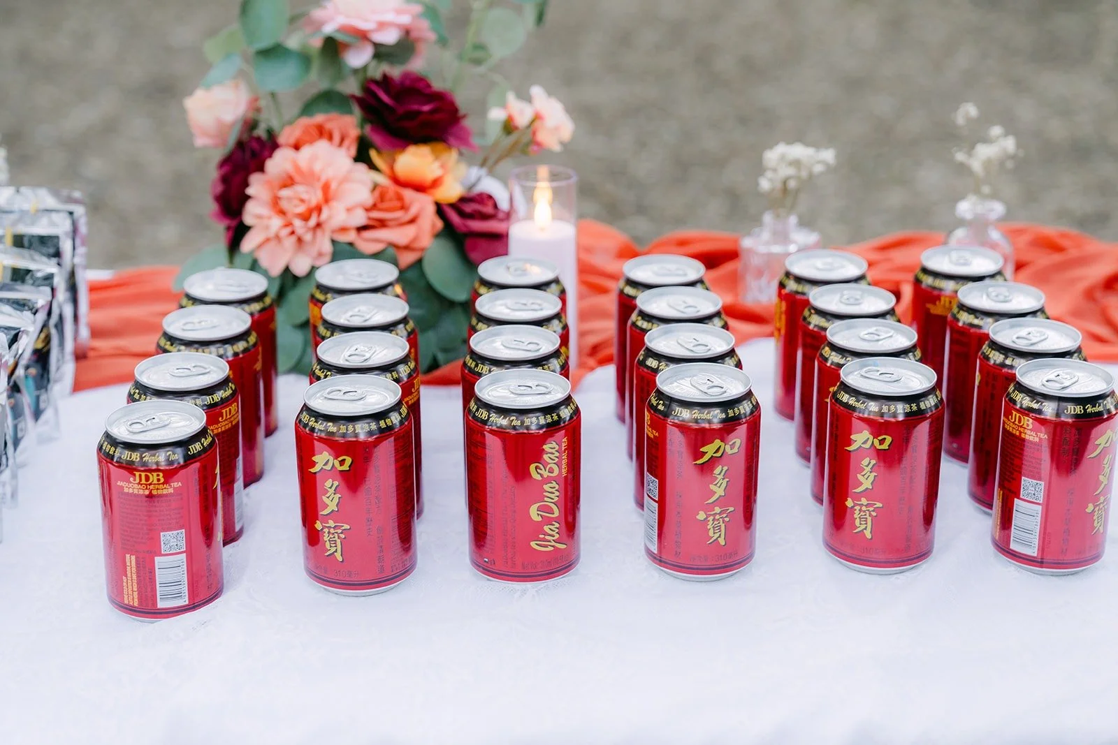 Rows of red favors lined up on the welcome table