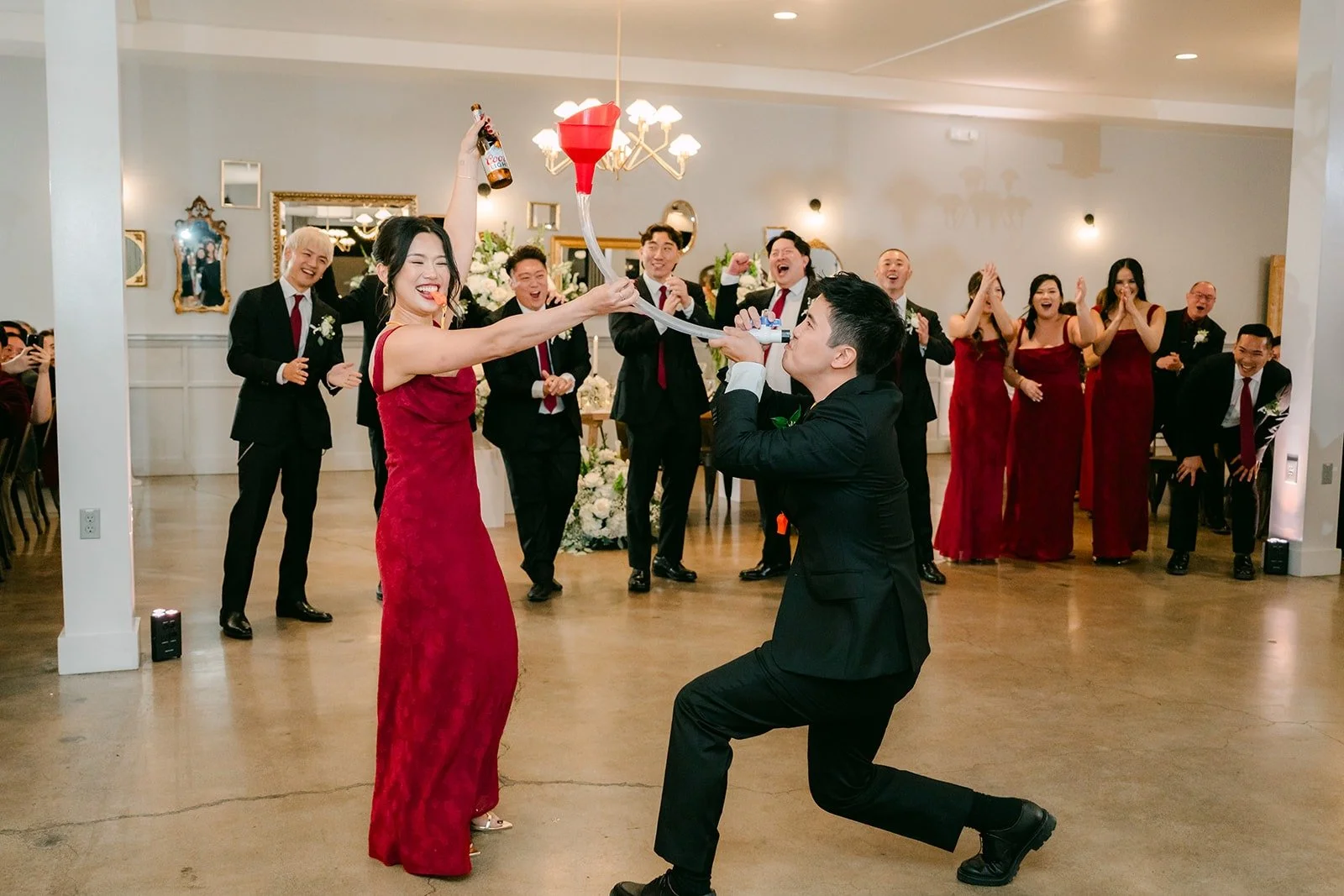 A groomsman dropping to one knee for a bridesmaid during the entrance