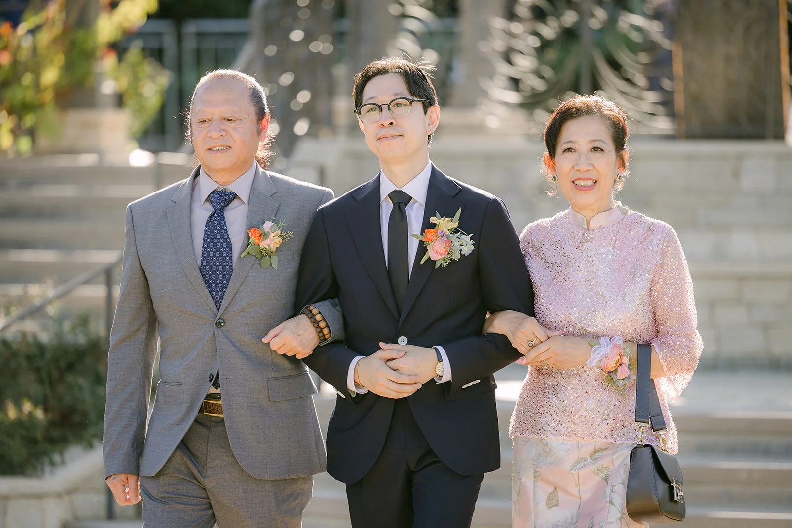 Leroy arm in arm with his parents during the processional