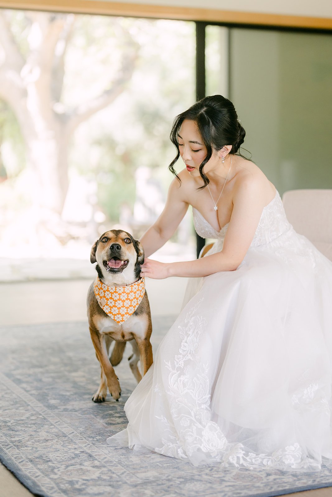 Yishan kneeling beside her dog Bagel while getting ready