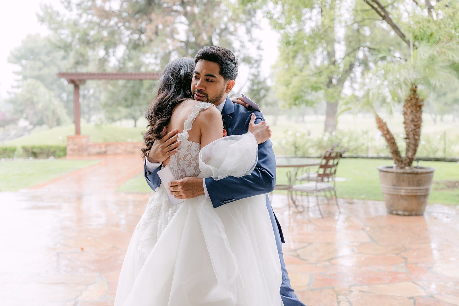 Natalie and Mark hugging on the patio after exchanging private vows