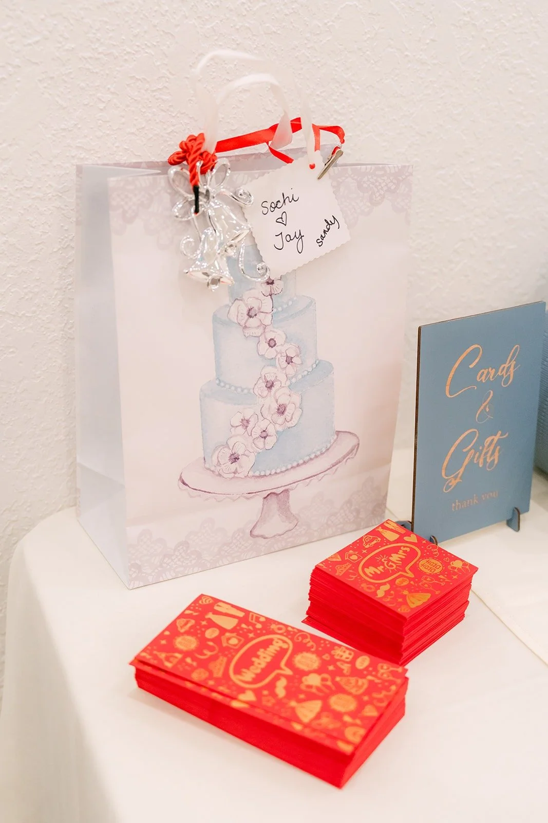 Red favor boxes and a gift bag at the reception