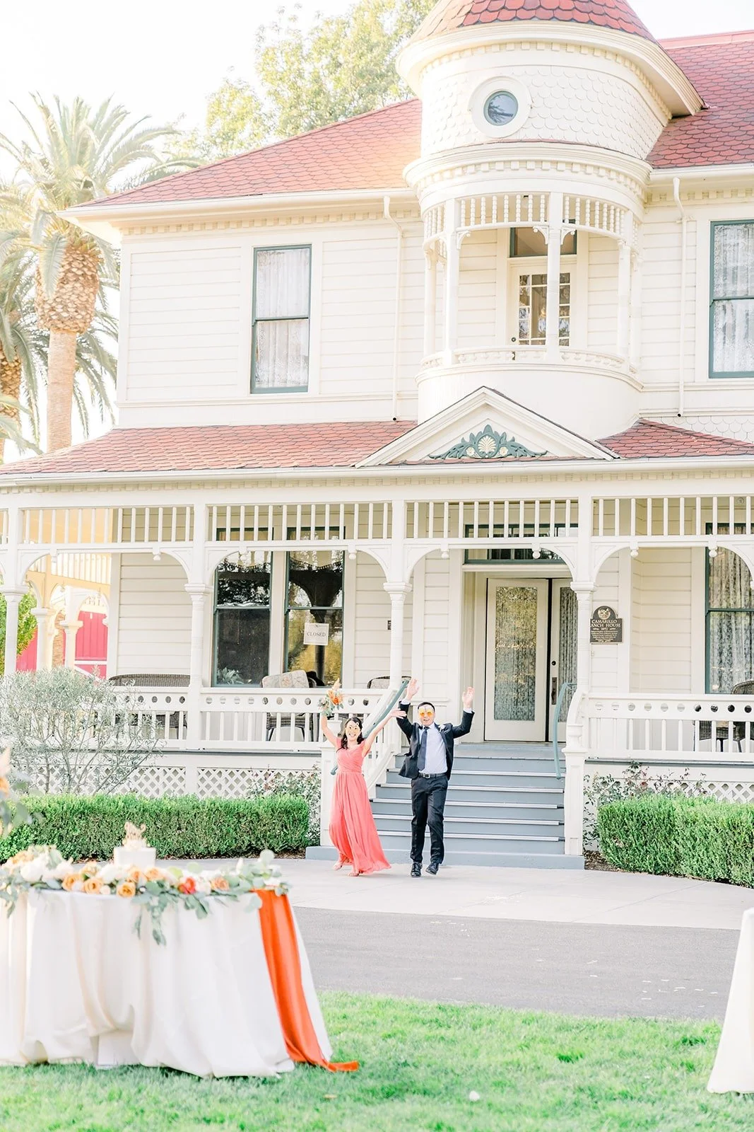 The wedding party entering down the steps of the ranch house