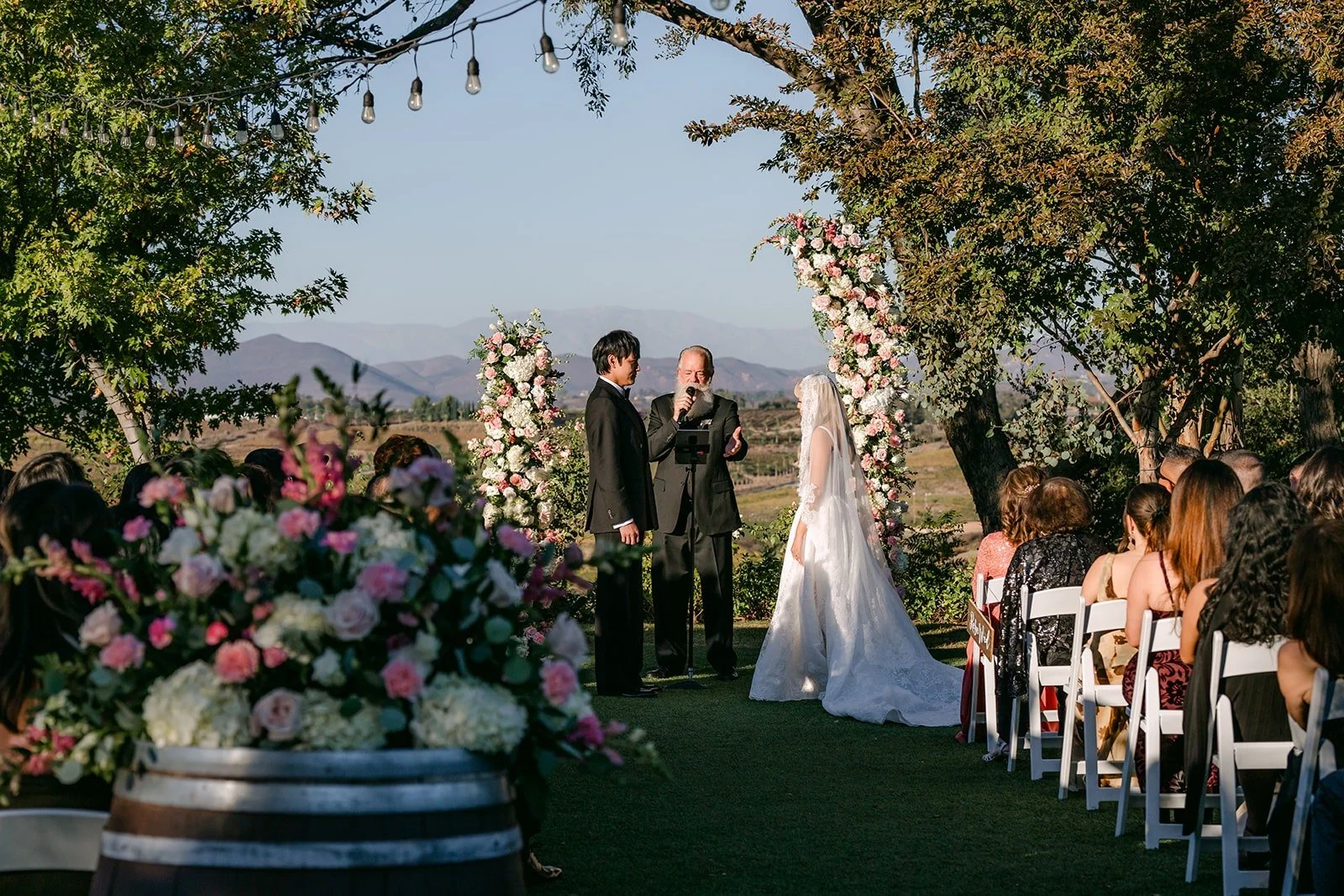 Wide view of the ceremony under the oak tree at Bel Vino Winery