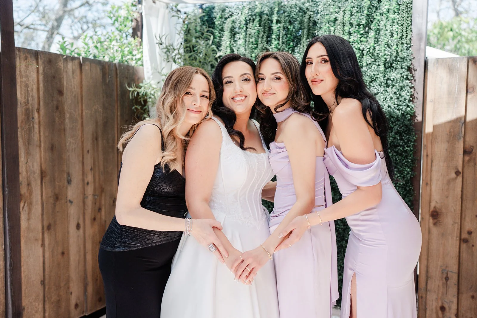 Bride with her sisters and bridesmaids in lavender dresses