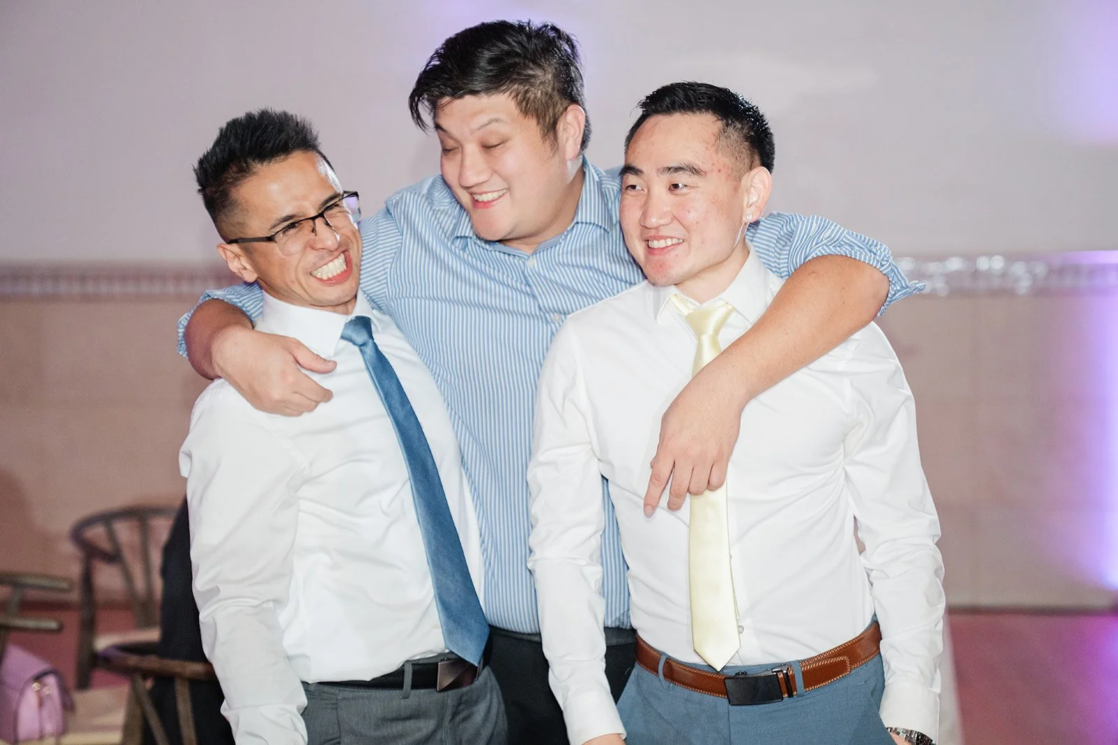 Groomsmen hugging on the dance floor
