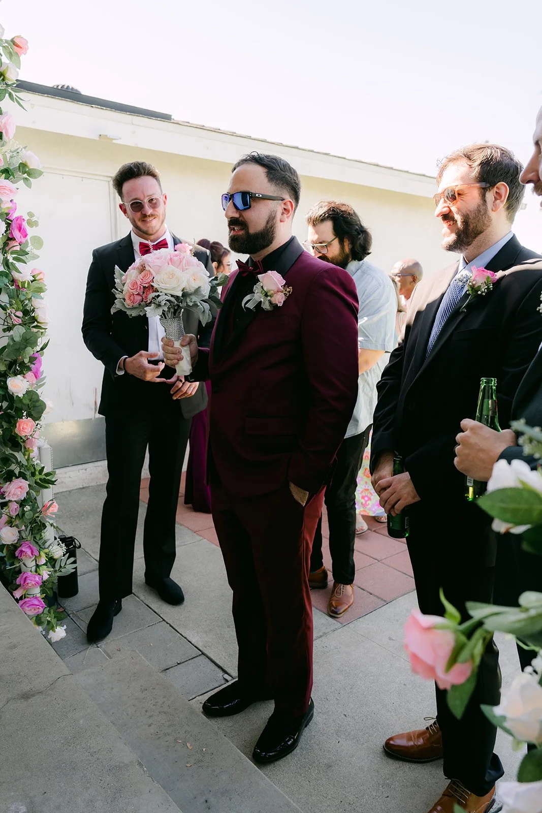 Ryan and his friends walking up to the house with the bouquet.