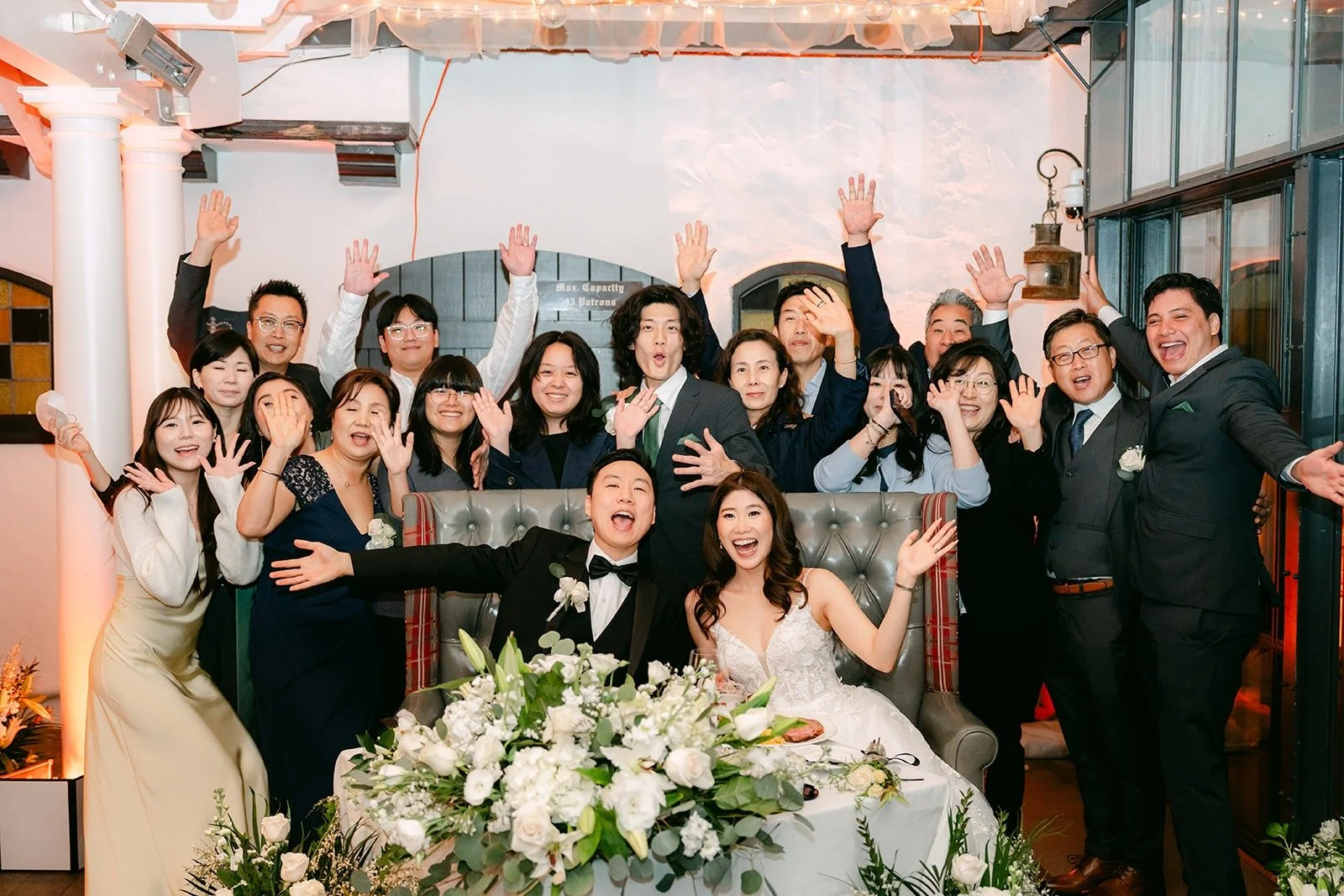 Guests cheering behind the sweetheart table