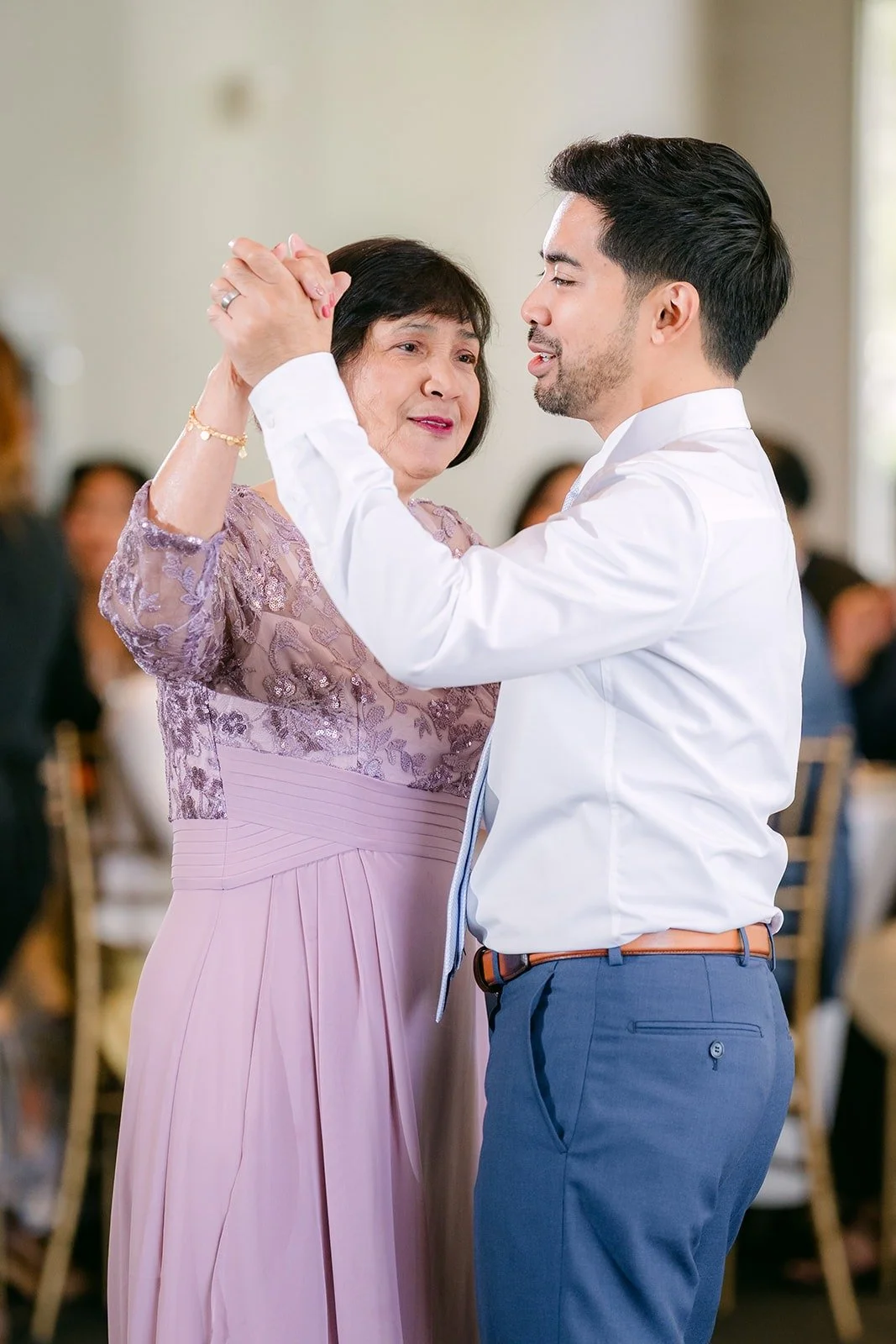 Mark dancing with his mom in a lavender dress