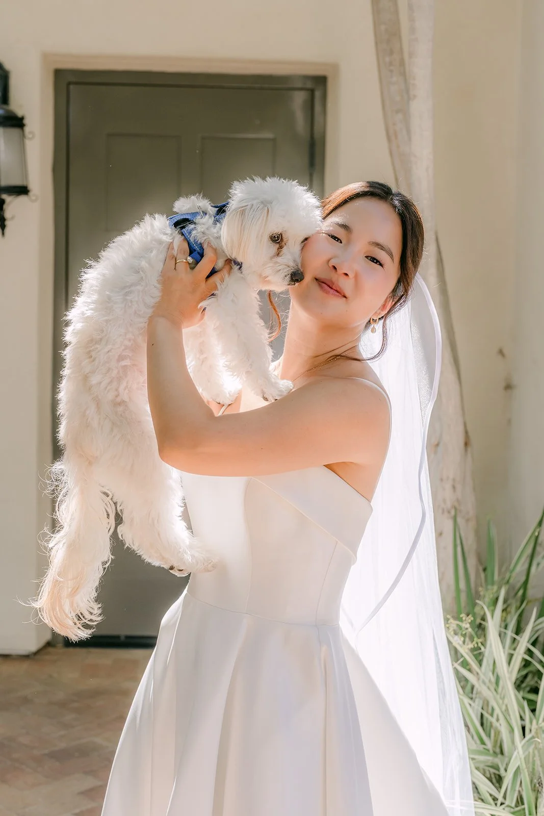 Saya holding her dog close to her cheek