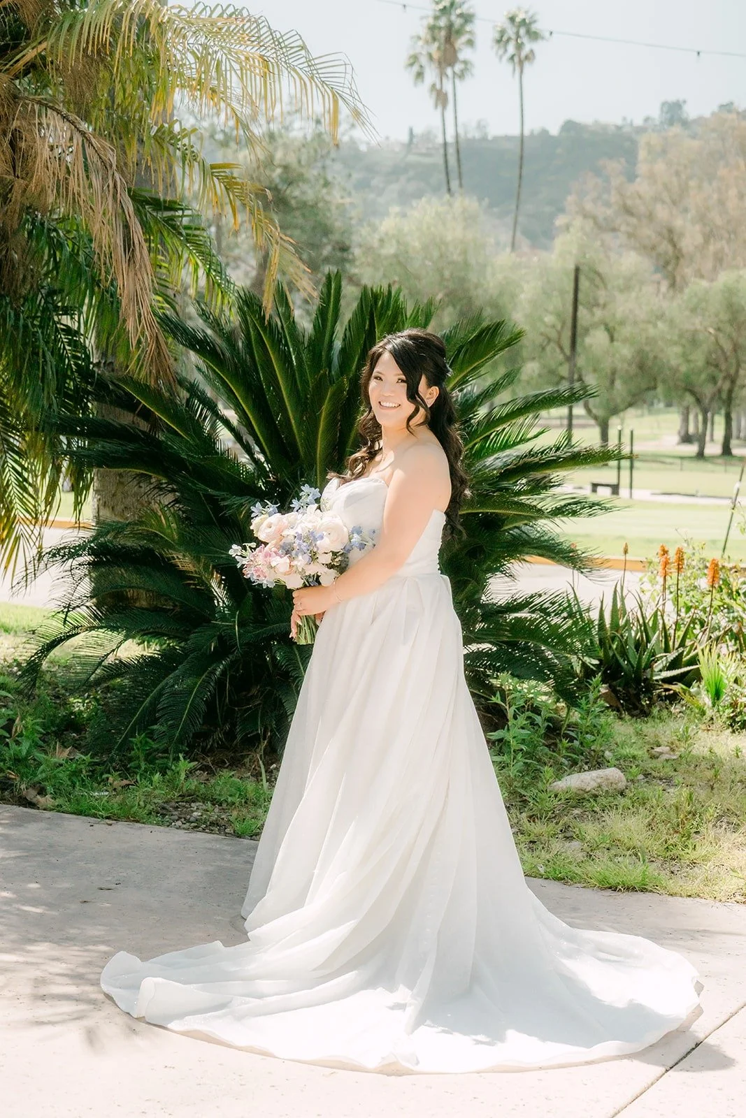 Florence in her strapless gown among the palms at Brookside Golf Club