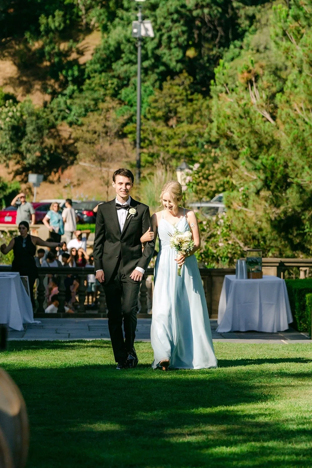 A groomsman and bridesmaid walking down the aisle