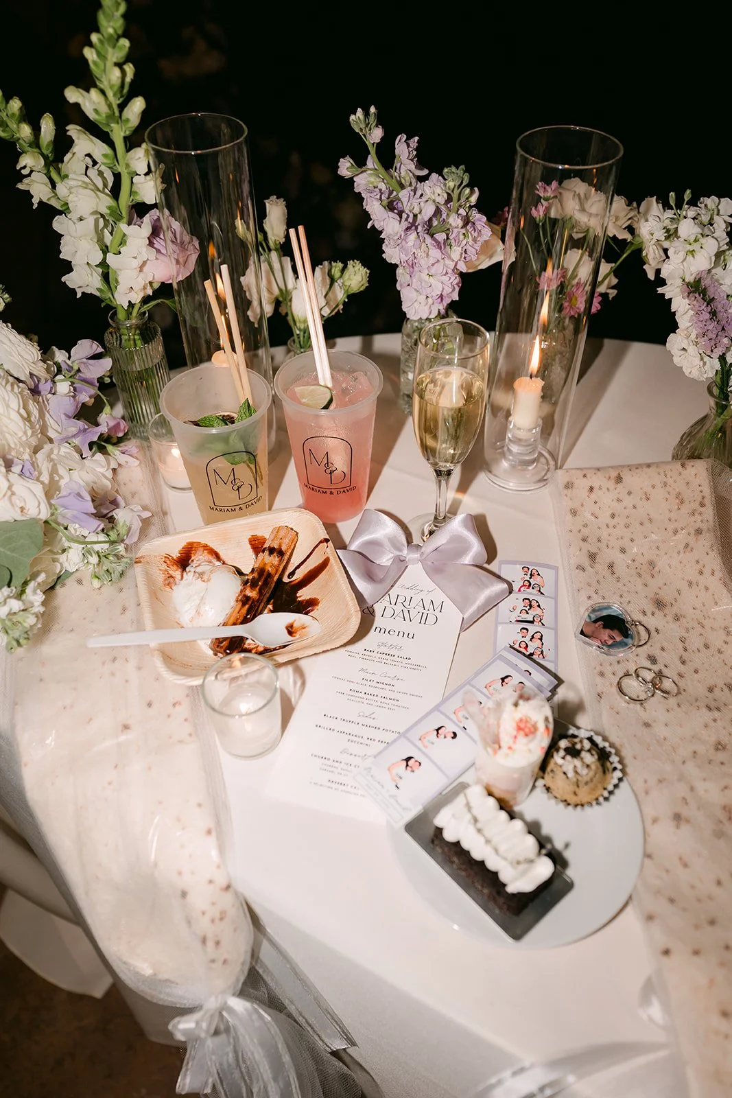 Sweetheart table at night with drinks, menus and desserts