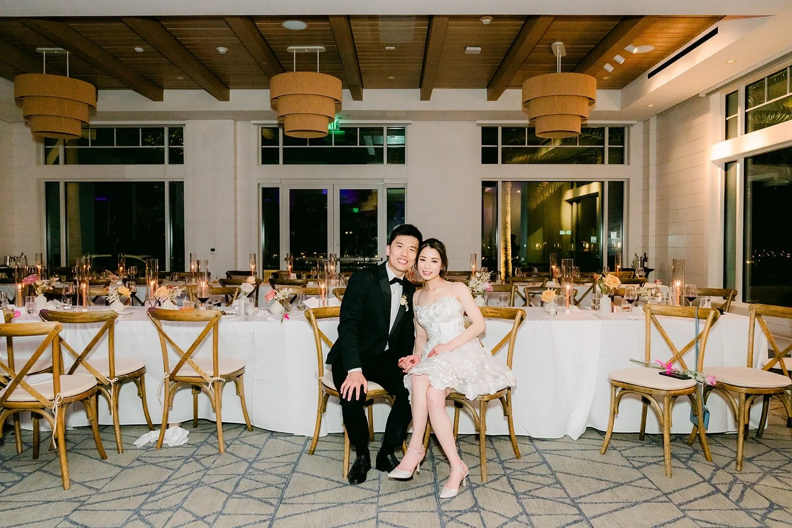 Angela and Eli sitting together in the ballroom before the guests arrive, photographed by One and Only Production