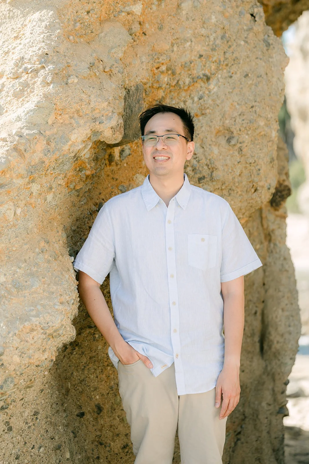 Lawrence leaning against the sandstone rock.