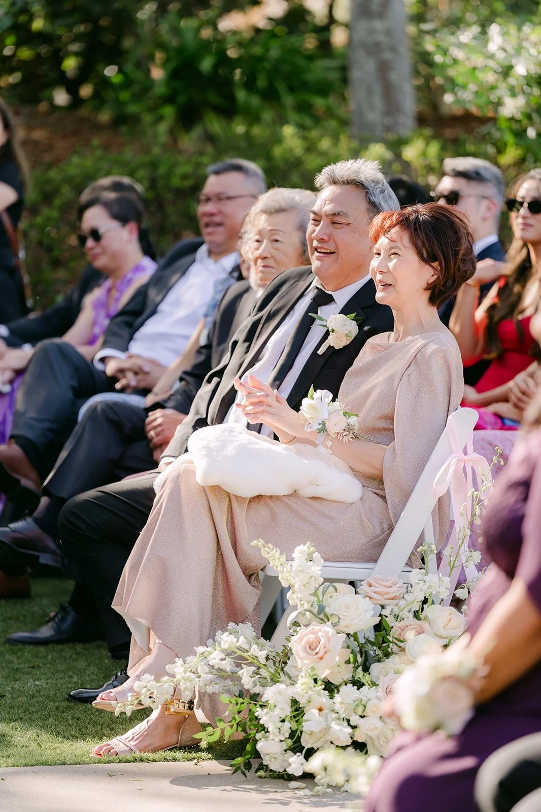 Guests smiling during the ceremony in the afternoon light