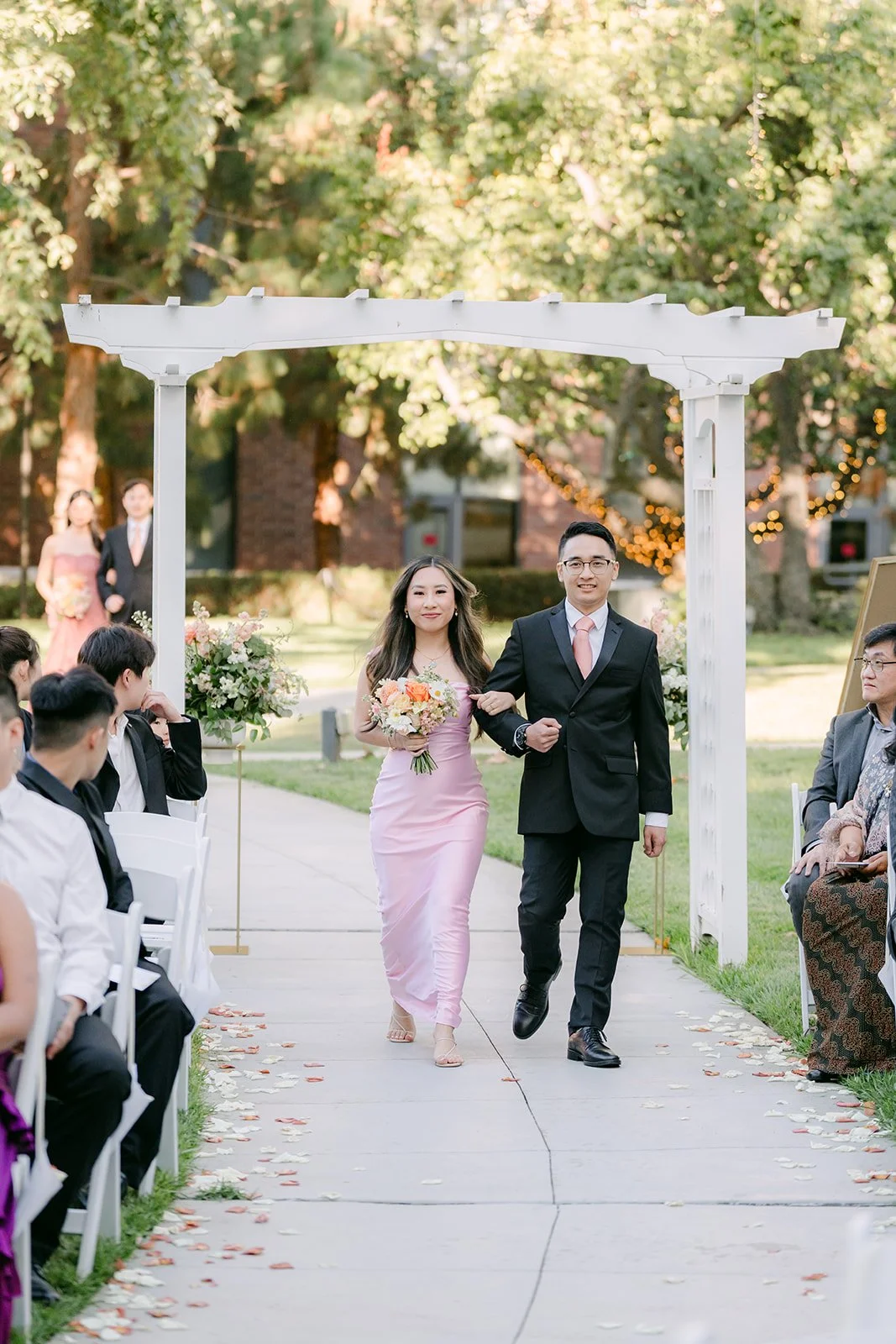 A bridesmaid walking down the aisle