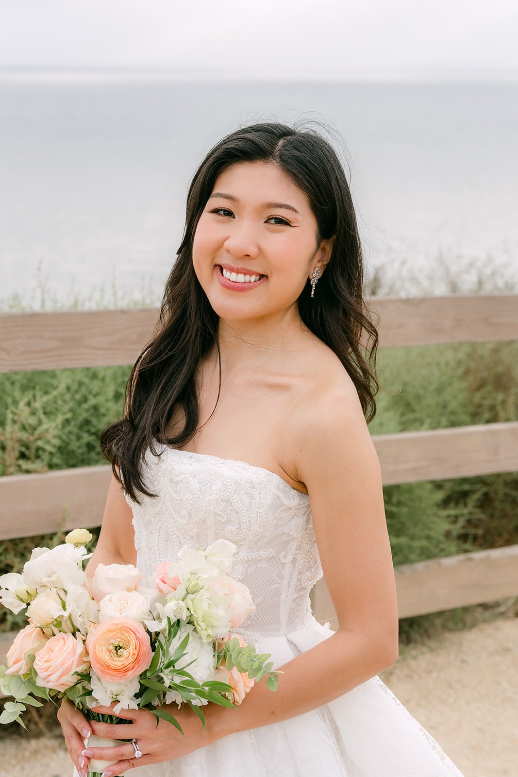 Kim smiling with her bouquet on the bluff