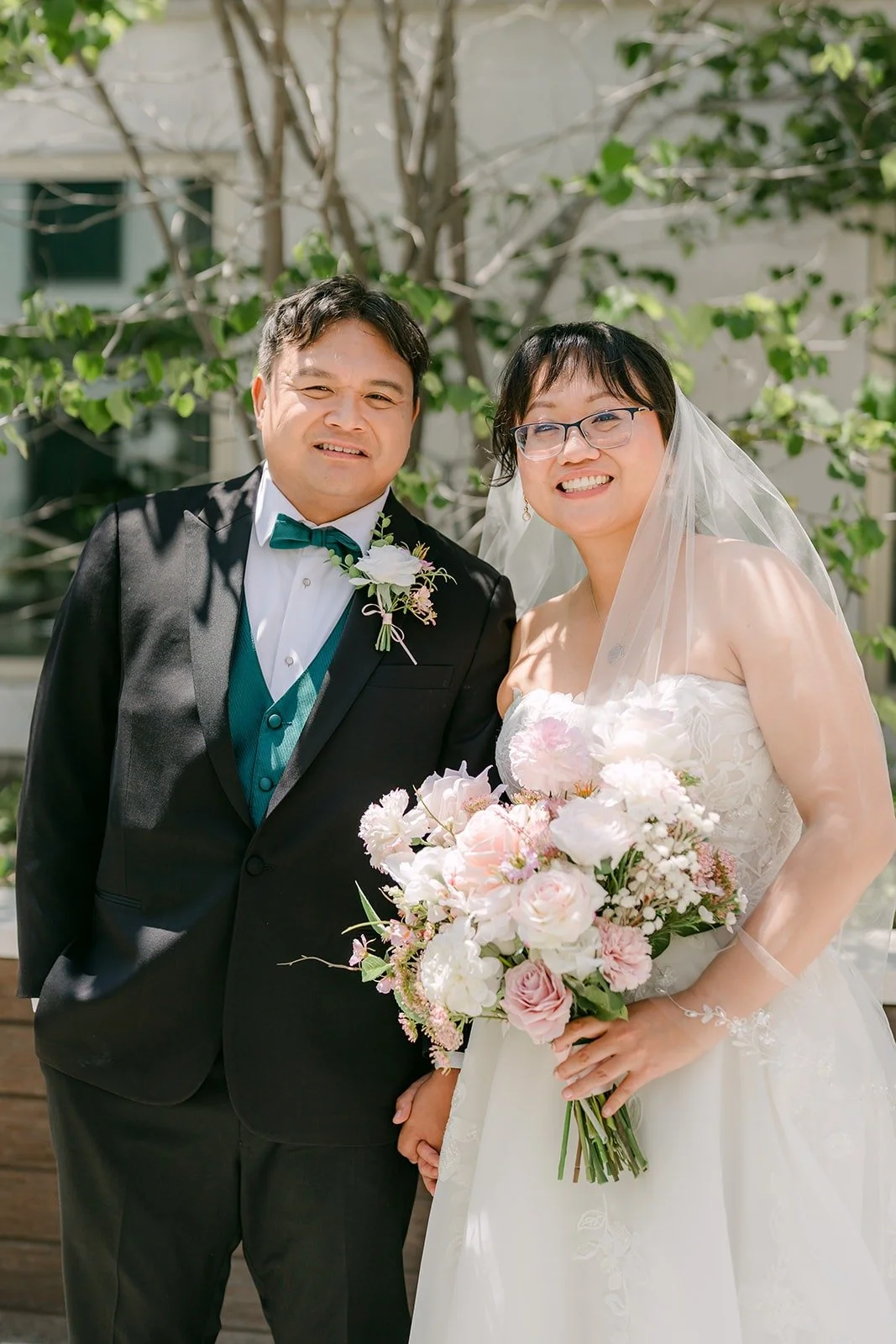 Stella and James smiling together after their first look in the courtyard