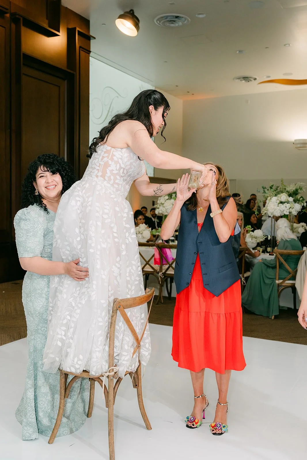 Fernanda lifted up in a chair by friends.