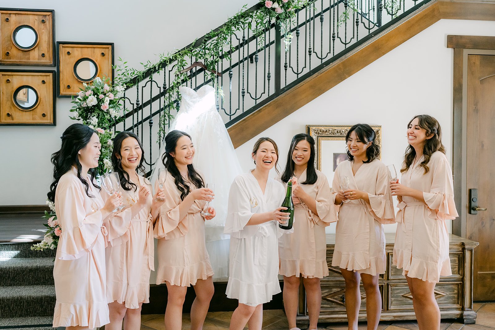 Bride and bridesmaids sharing champagne in matching robes
