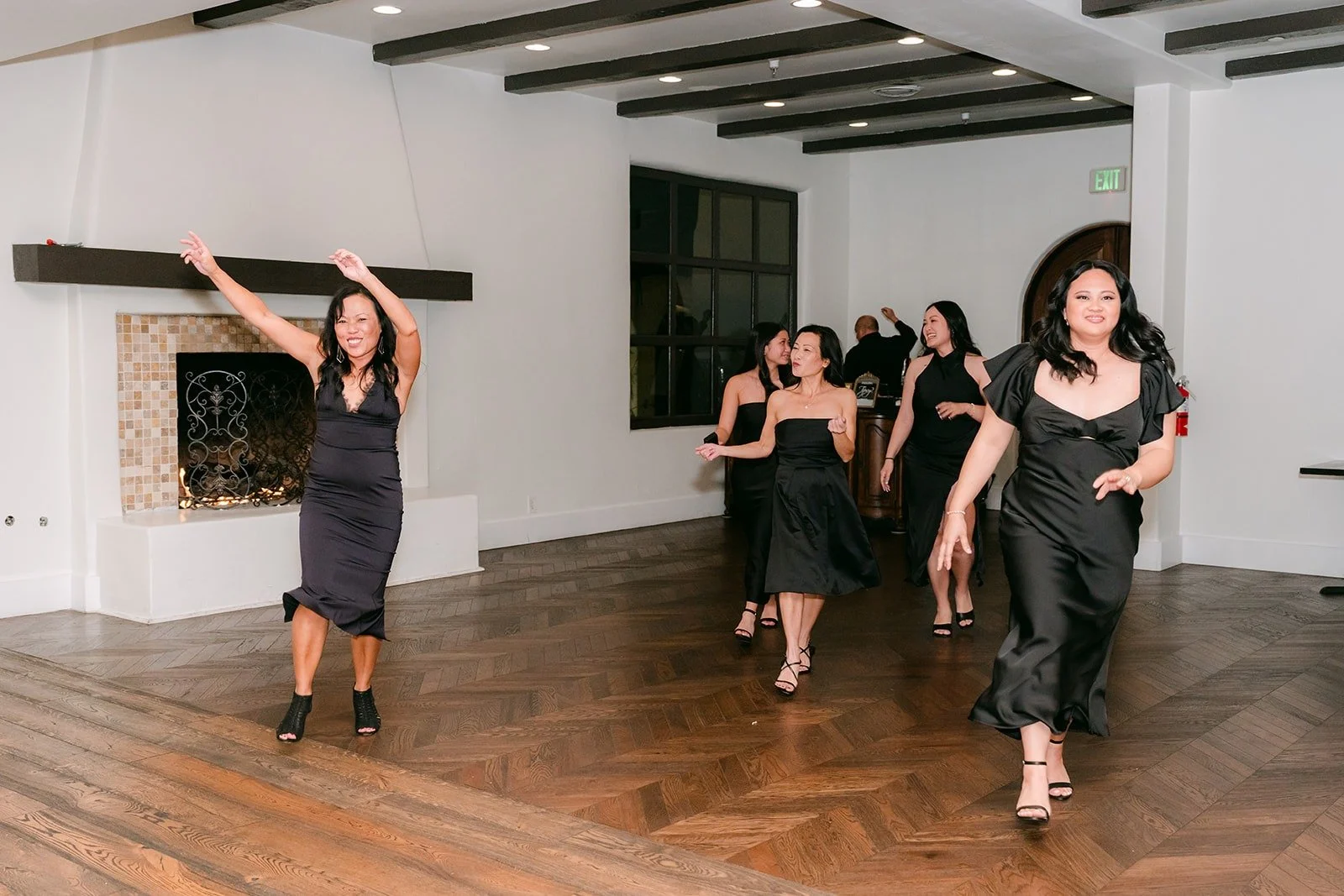A bridesmaid dancing into the ballroom